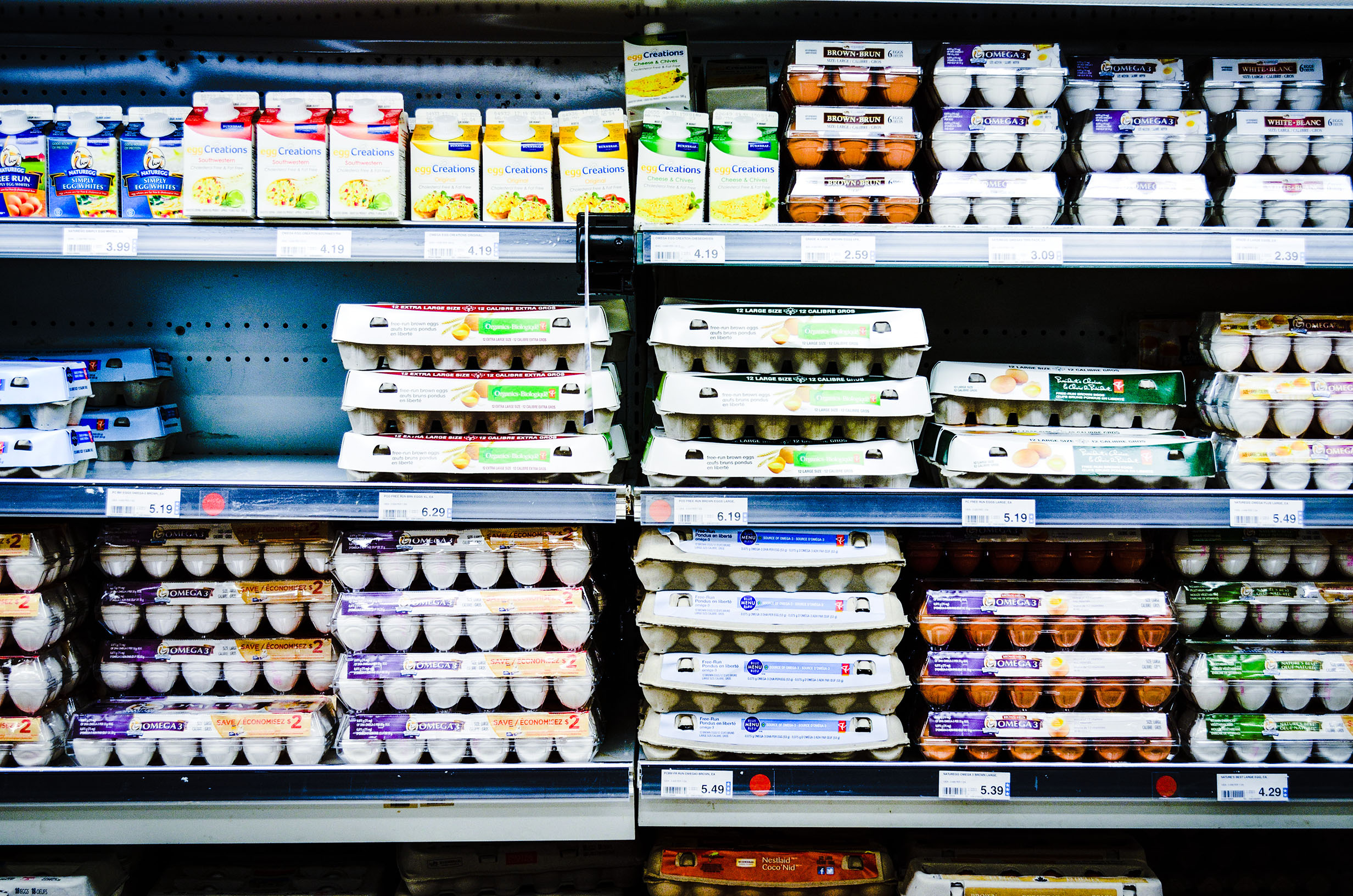Eggs on display in a grocery store aisle.
