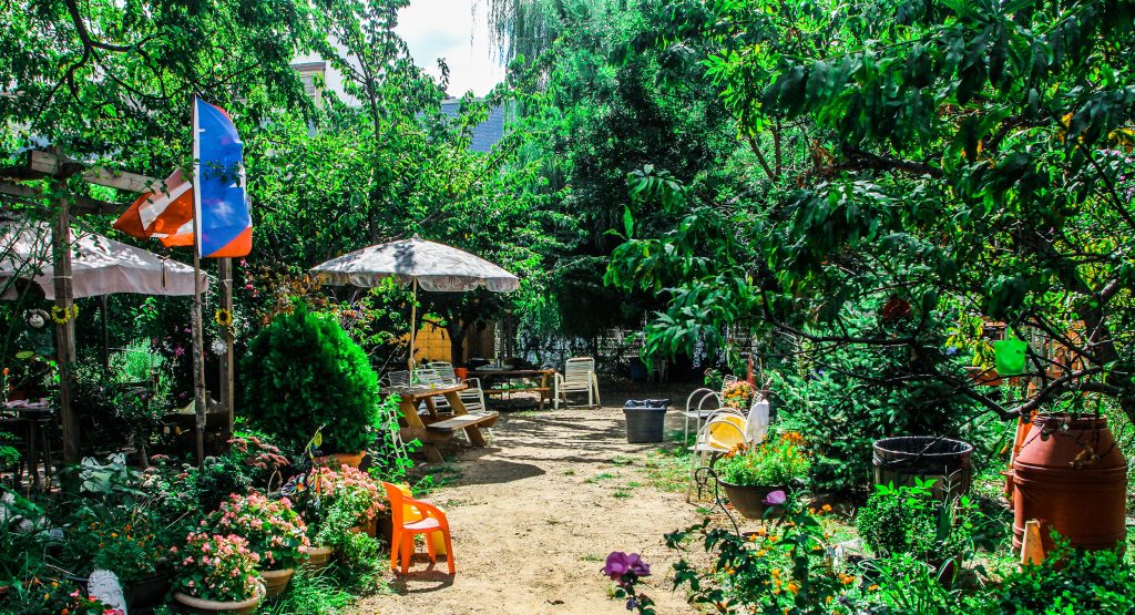 A picture of lush garden with seating areas in East Harlem, New York City. 